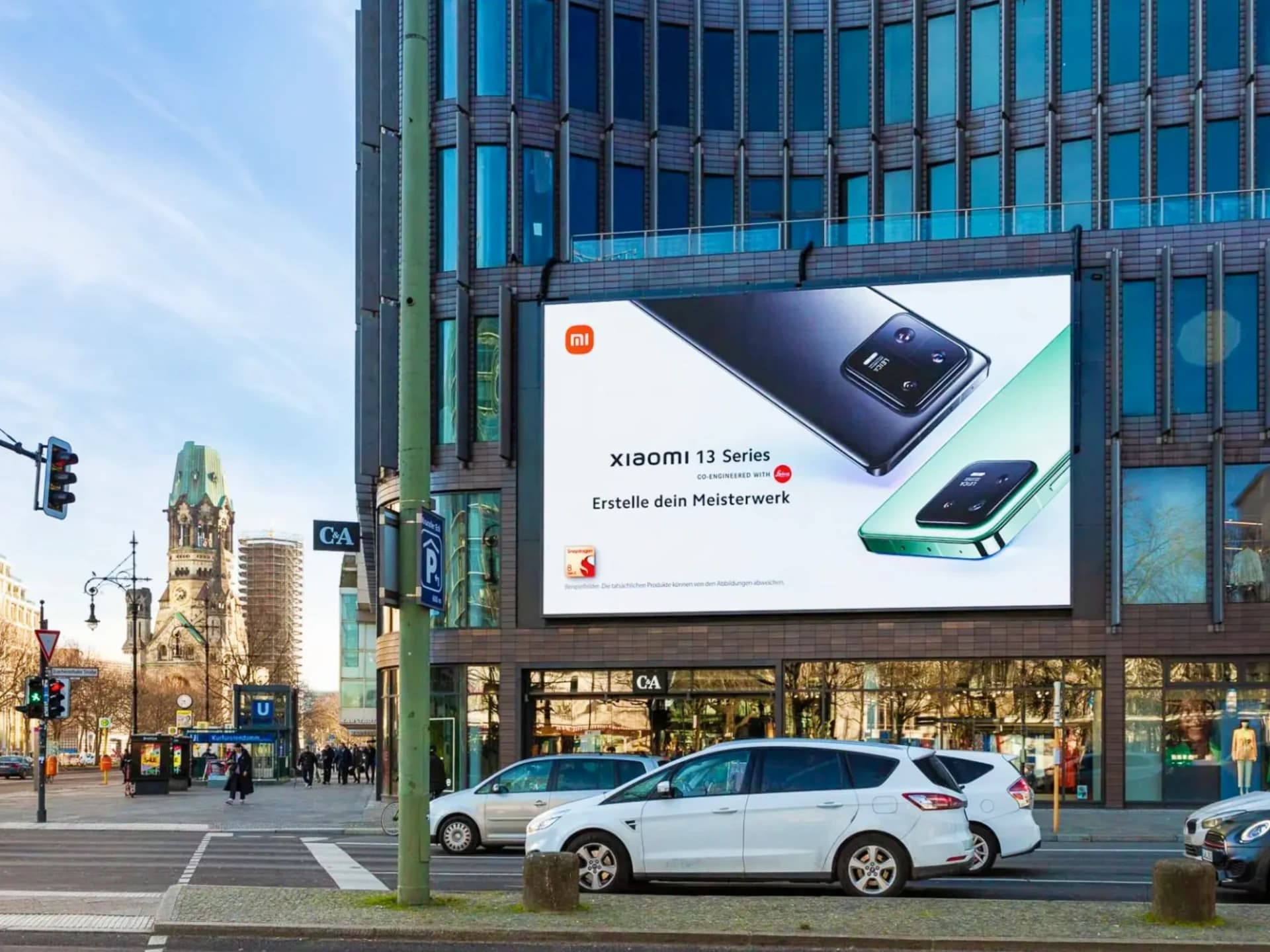 Billboard advertising: a Xiaomi 13 Series board covers the front of a glass office building.