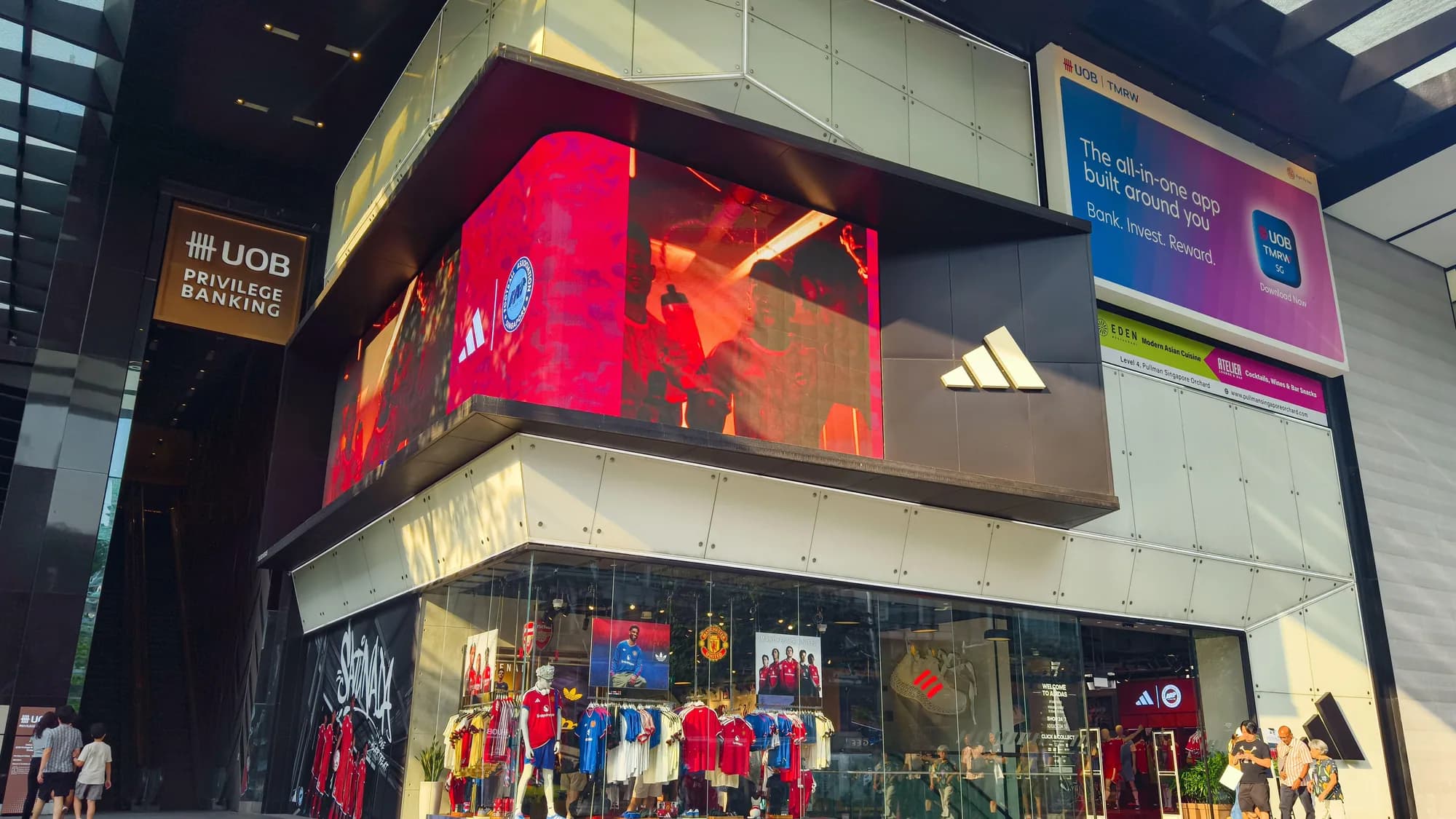 Building advertising on Orchard Road in Singapore: Shaw House shows an IMAX announcement for 13 January, above Isetan and Lido signage.