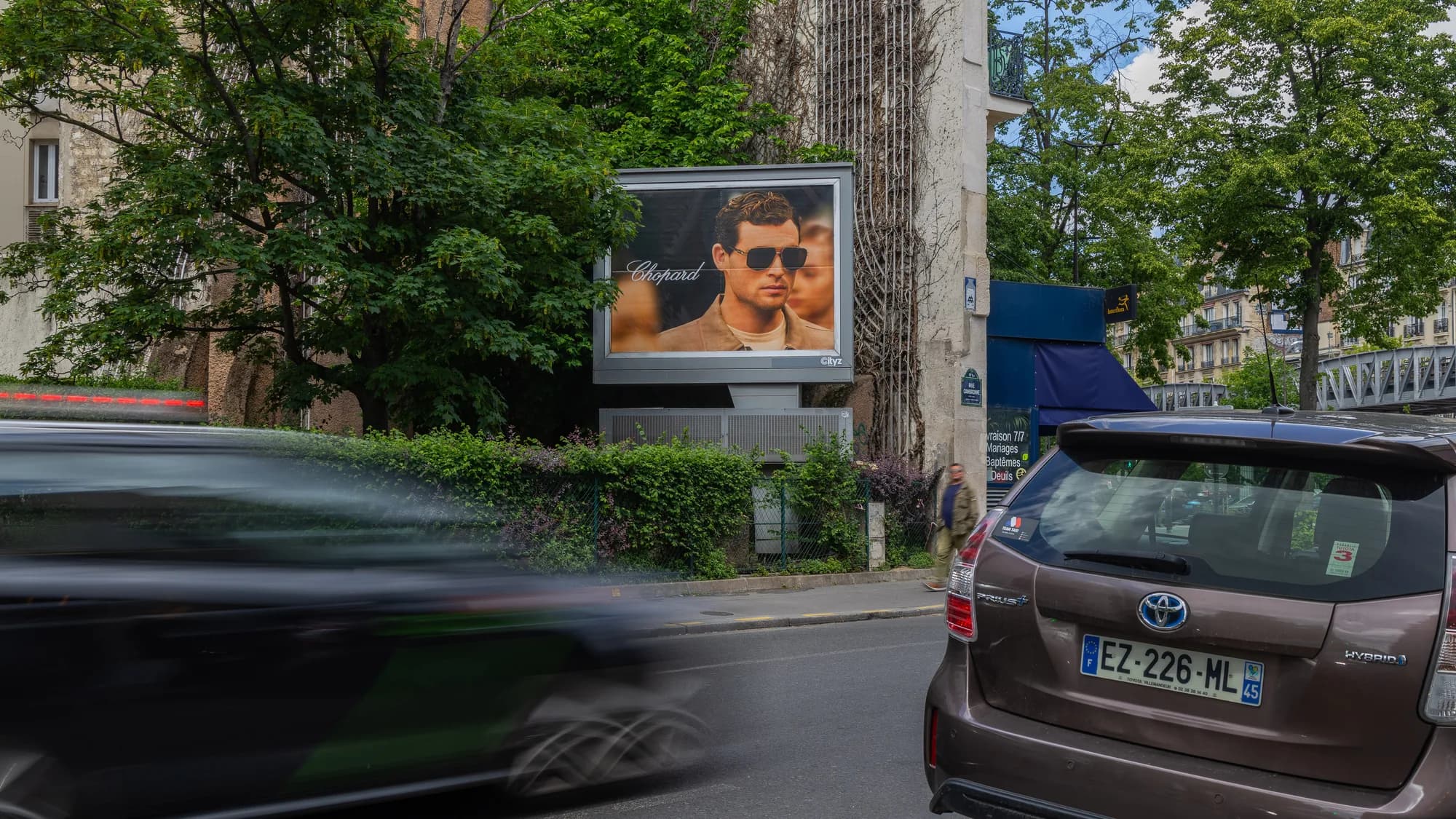 Digital out-of-home advertising in Paris, in France: a ba&sh screen with Abby Champion covers the Galeries Lafayette facade at night.