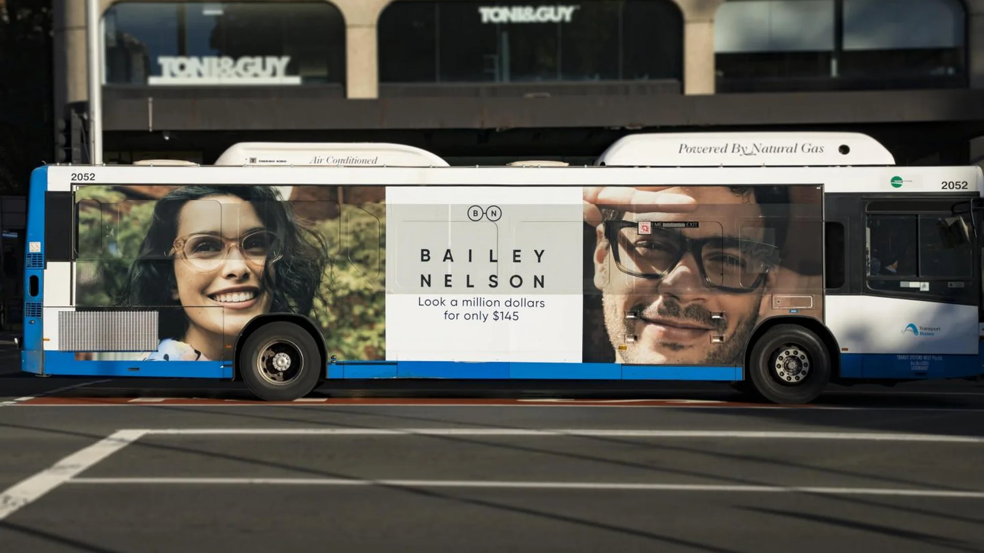 Bus advertising in Australia: a bus carries a Bailey Nelson wrap reading Look a million dollars for only $145.