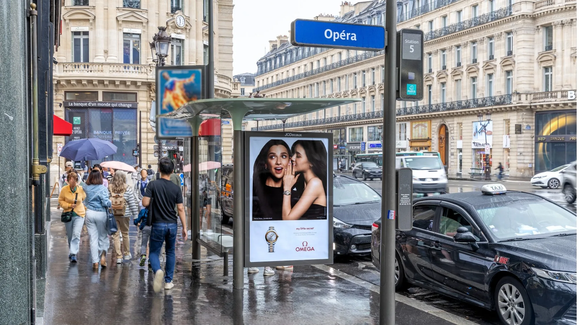 Street furniture advertising in Paris, in France: a bus shelter by Opéra station carries an Omega poster reading my little secret.