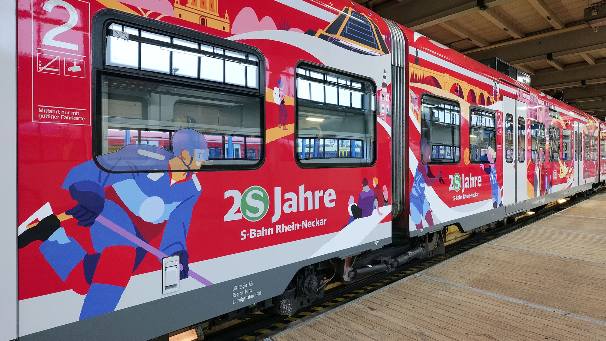 Rail advertising on the S-Bahn Rhein-Neckar in Germany: a red DB Regio train marks 20 Jahre, with an ice hockey player on the side.