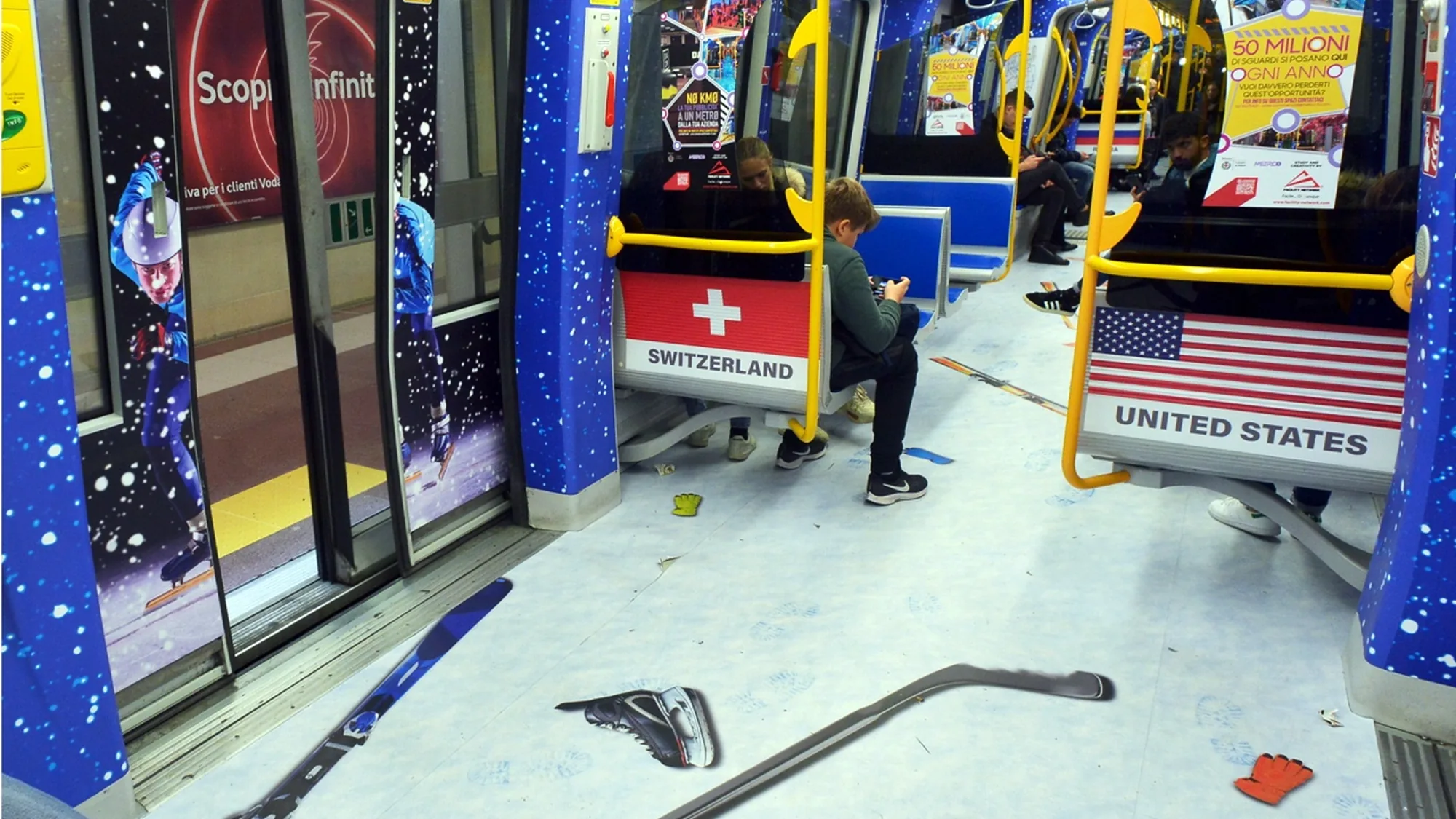 Metro advertising in Italy: a carriage is wrapped with Switzerland and United States seat backs, a skier on the door, and ski and hockey graphics on the floor.