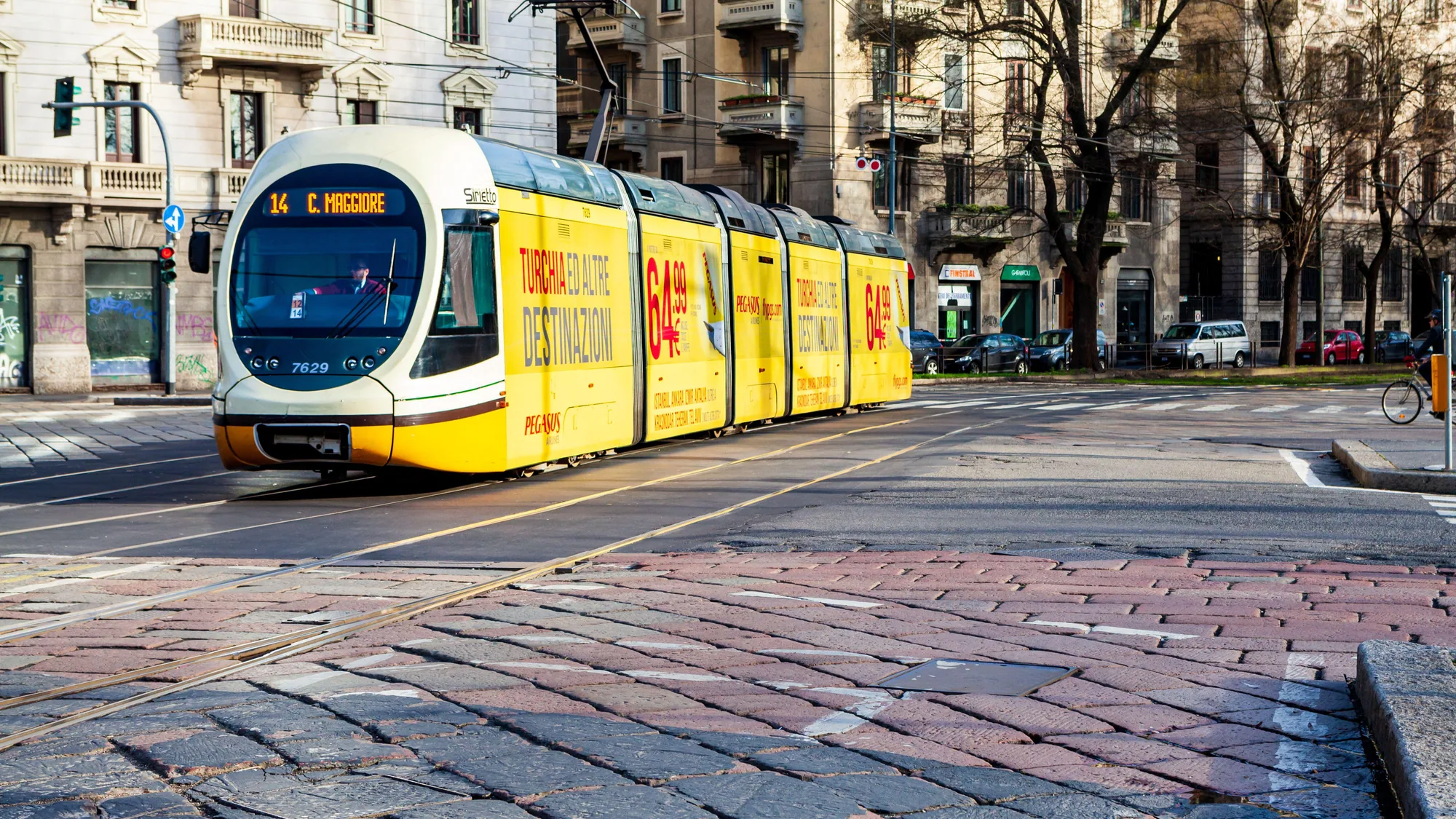 Tram advertising in Italy: a yellow tram on route 14 to C. Maggiore carries a Pegasus advert for Turkey and other destinations.