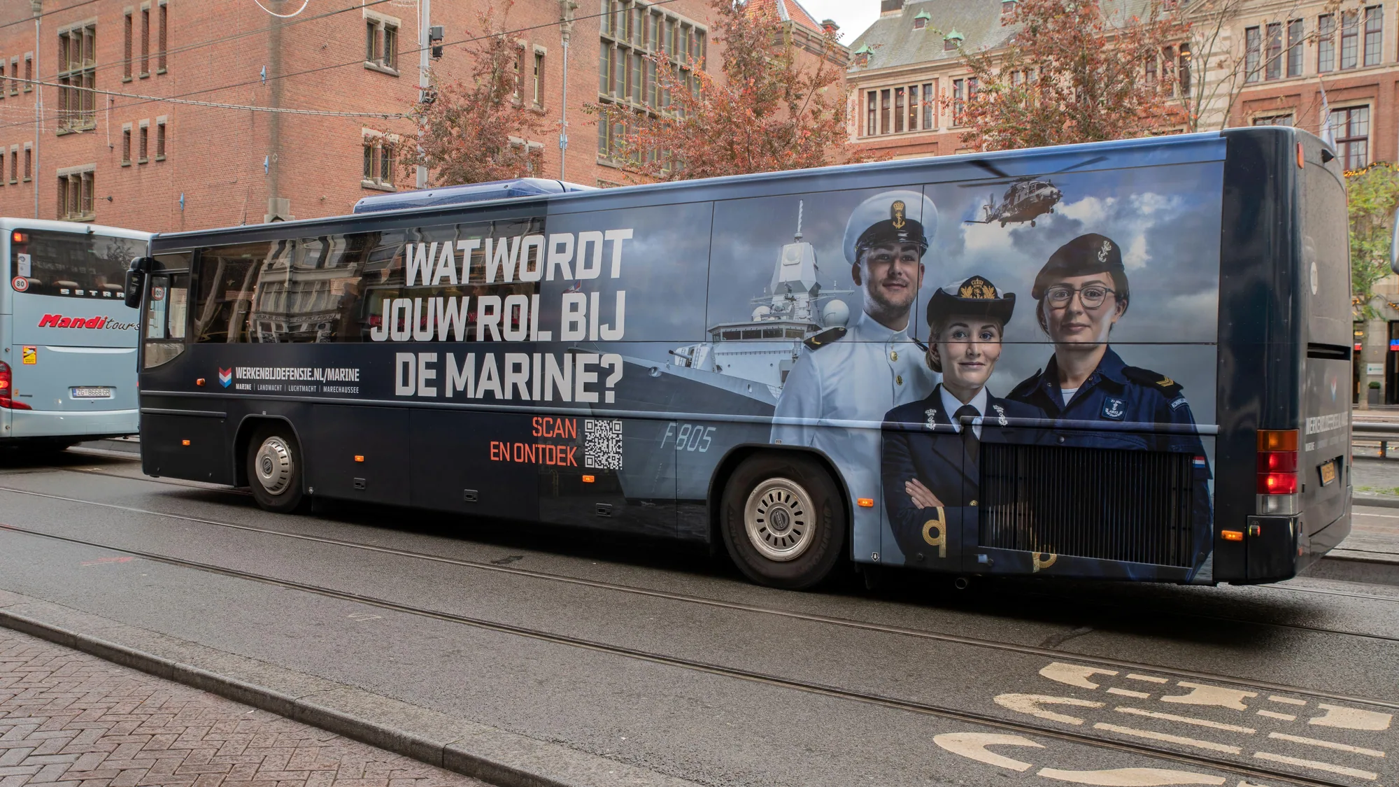 Bus advertising in Amsterdam, the Netherlands: a Dutch bus carries a Koninklijke Marine recruitment advert asking Wat wordt jouw rol bij de marine?