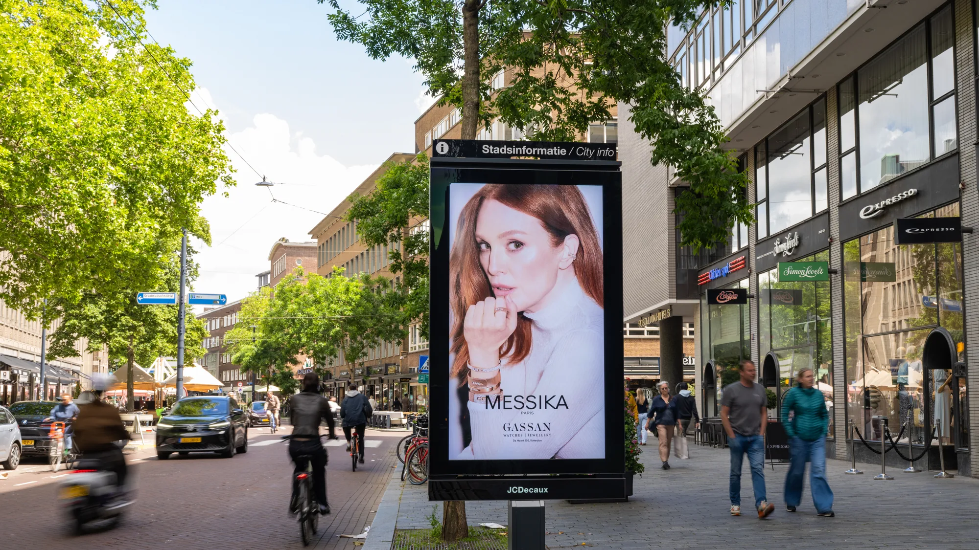 Programmatic digital advertising in the Netherlands: a city information screen shows a Messika jewellery advert with the name GASSAN.