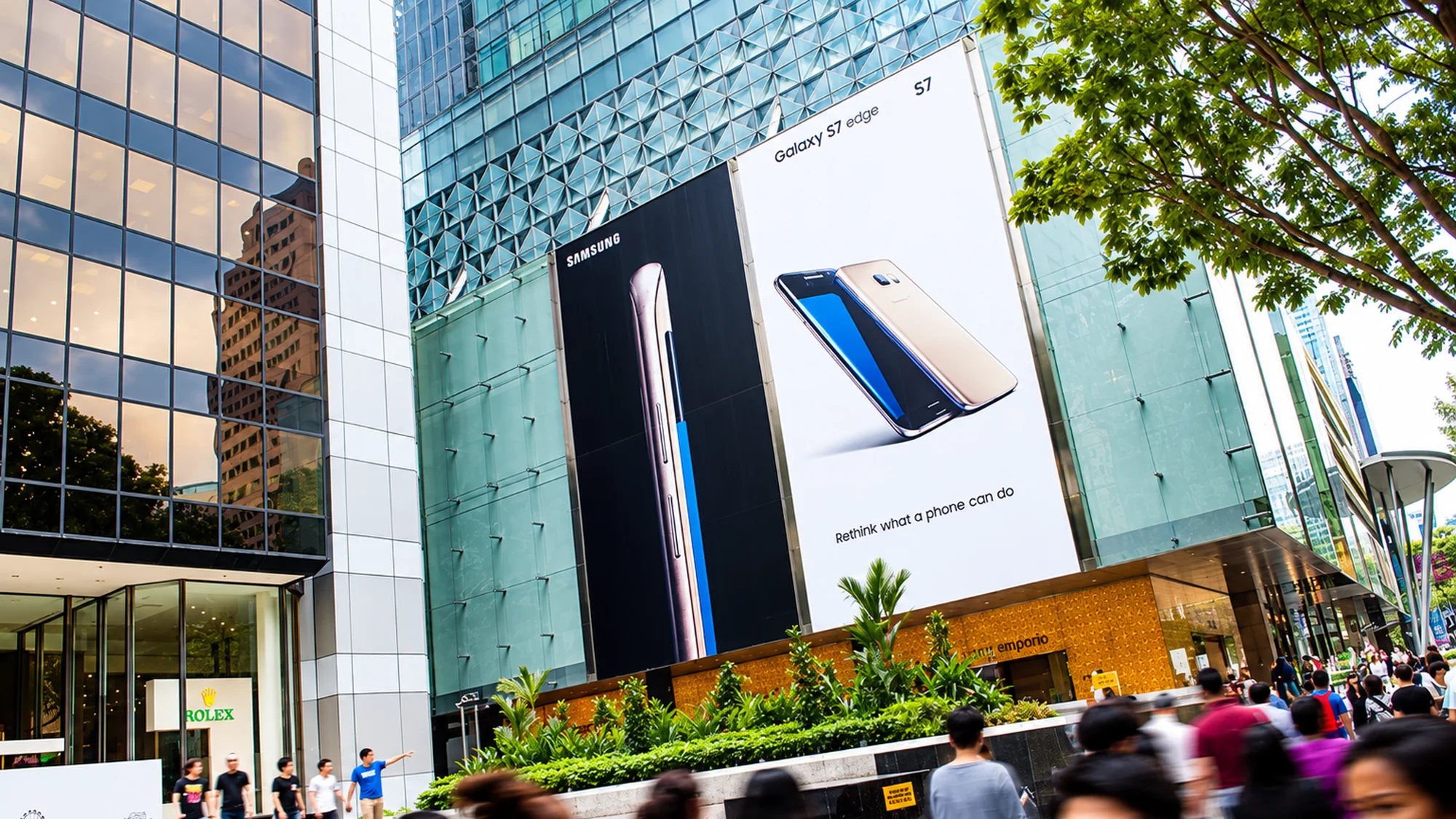 Building banner advertising in Singapore: Samsung Galaxy S7 edge banners carry the line Rethink what a phone can do, beside a Rolex shop.