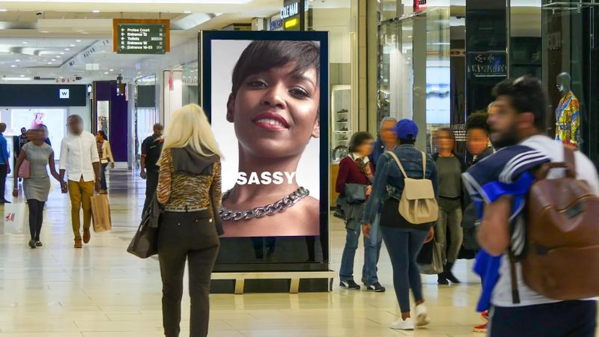 Digital out-of-home advertising in a South African shopping mall: a digital screen shows a Sassy jewellery advertisement.