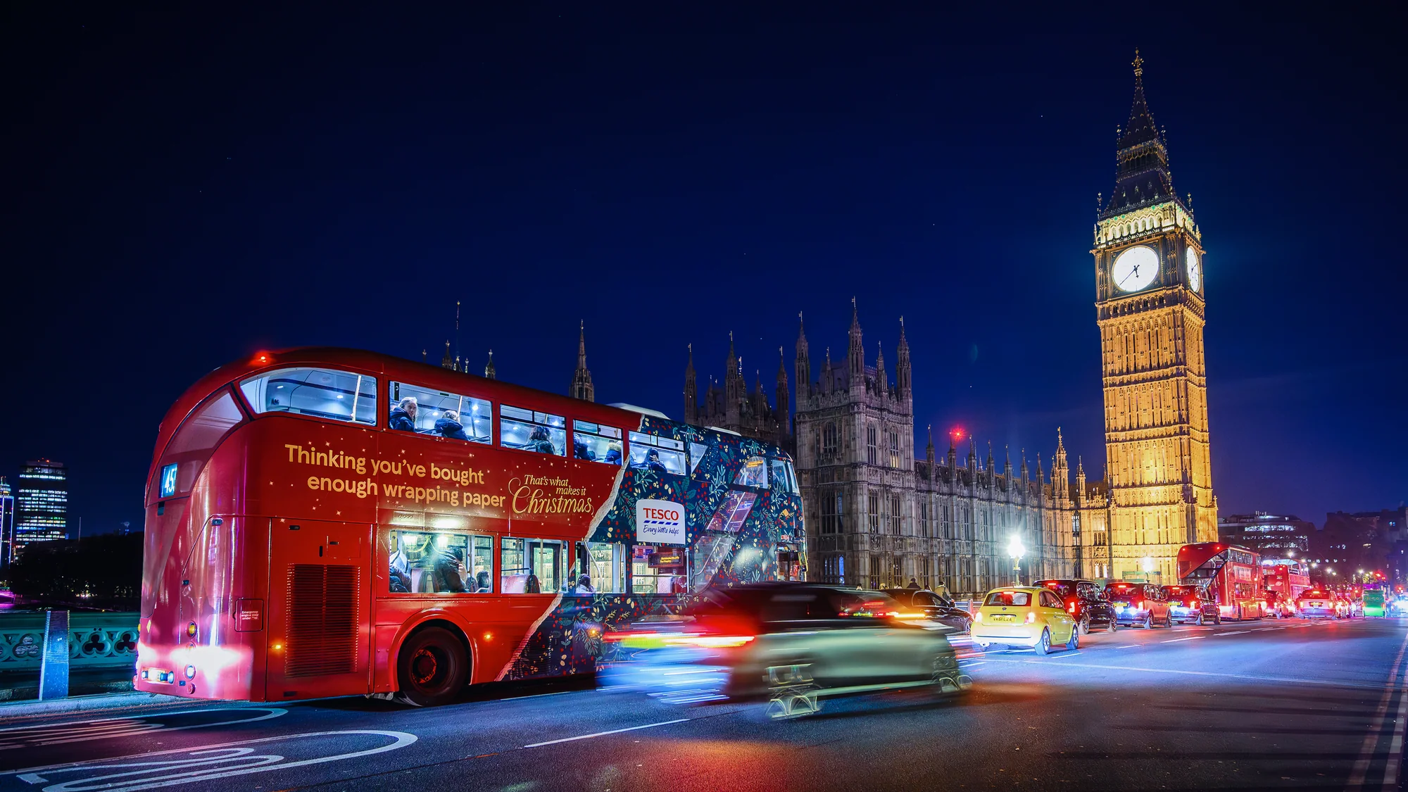 Bus advertising in London, in the United Kingdom: a Tesco Christmas wrap reads Thinking you've bought enough wrapping paper, with Big Ben behind it.