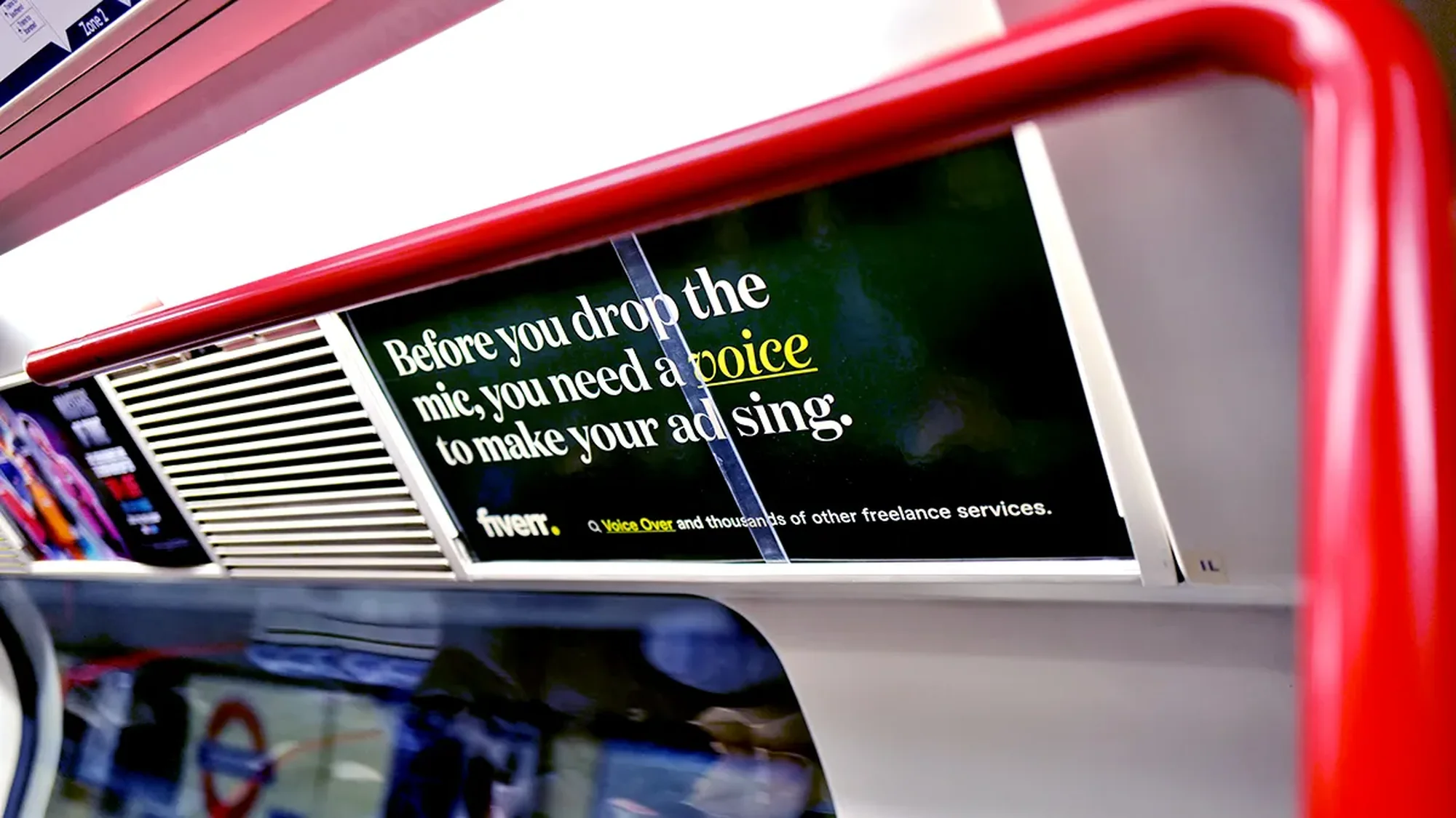 London Underground advertising in the United Kingdom: a carriage card for Fiverr reads Before you drop the mic, you need a voice to make your ad sing.