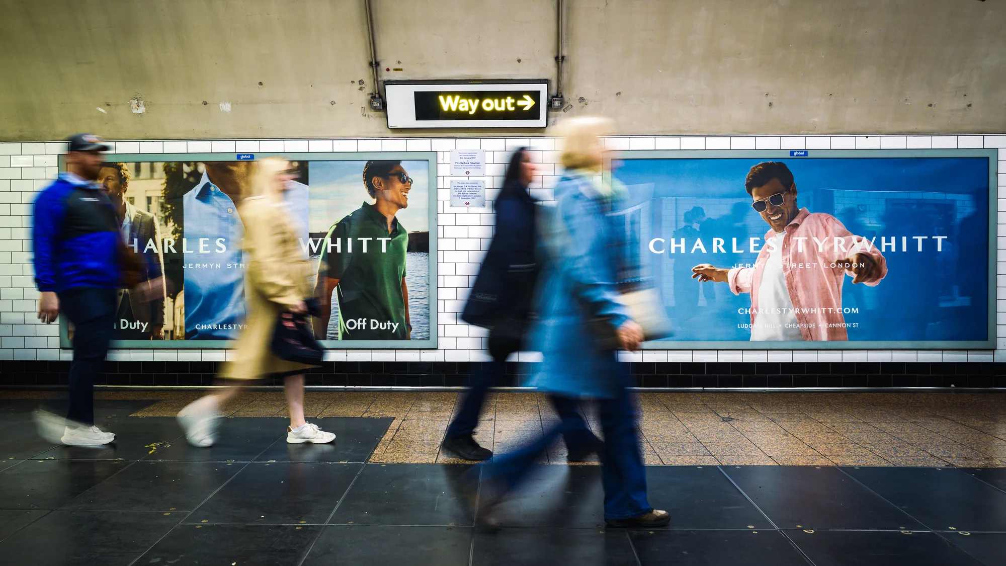 London Underground advertising in the United Kingdom: Charles Tyrwhitt posters show Jermyn Street shirts, one labelled Duty and one Off Duty.