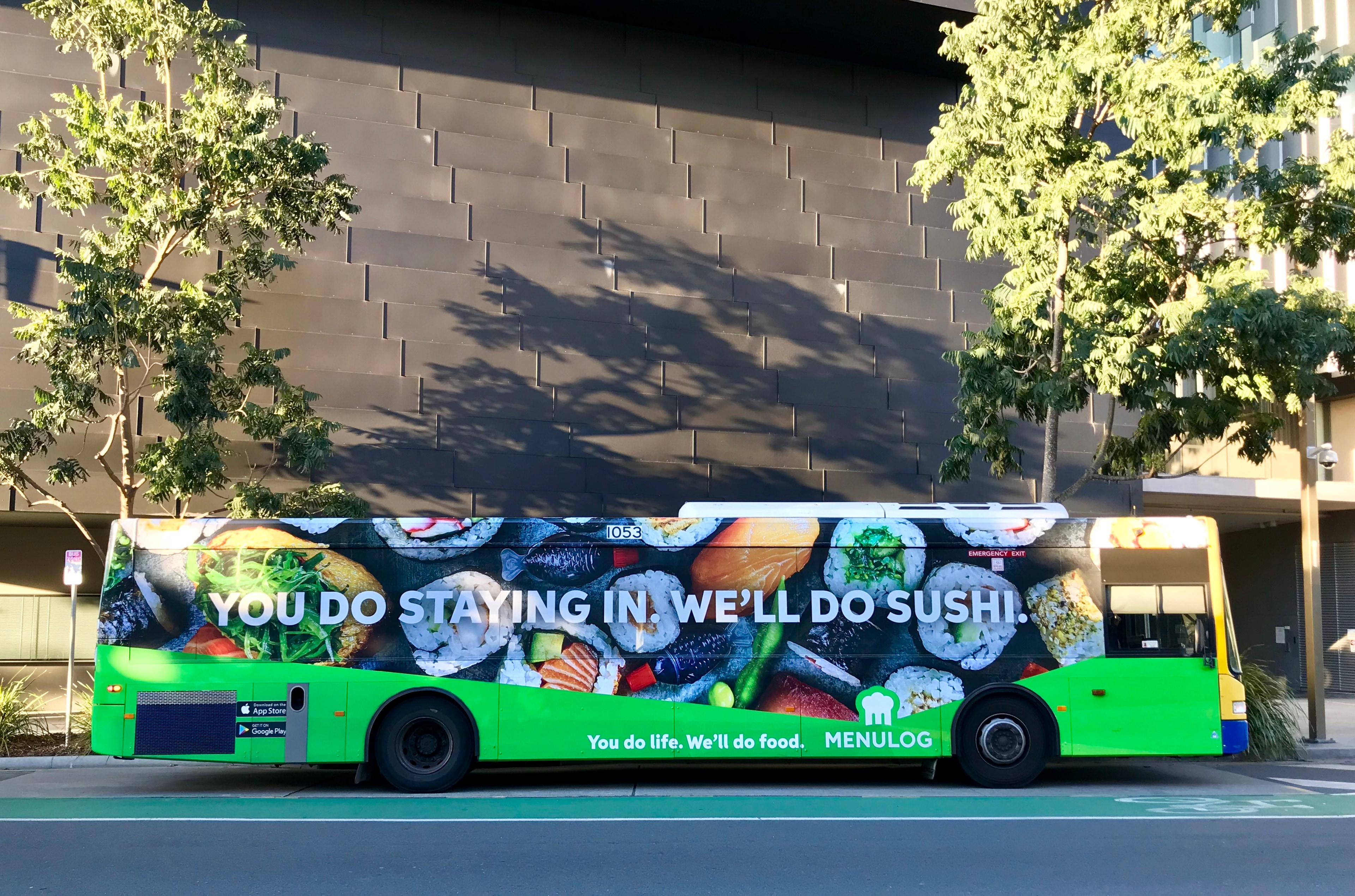 Bus advertising: a wrap in sushi imagery carries the Menulog line, You do staying in, we'll do sushi.