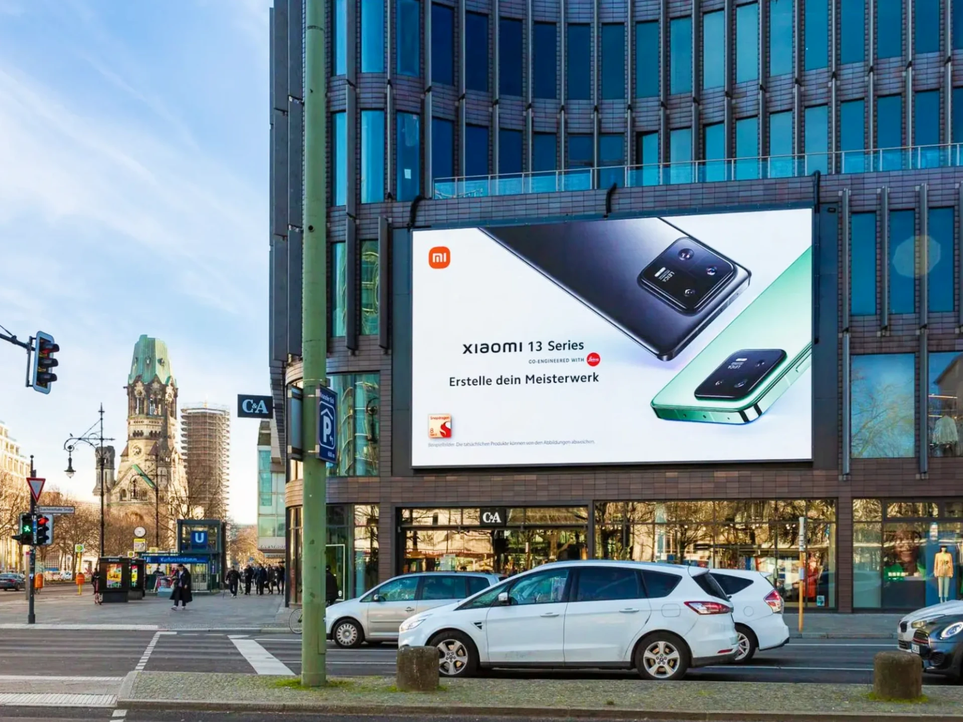Billboard advertising: a Xiaomi 13 Series board covers the front of a glass office building.