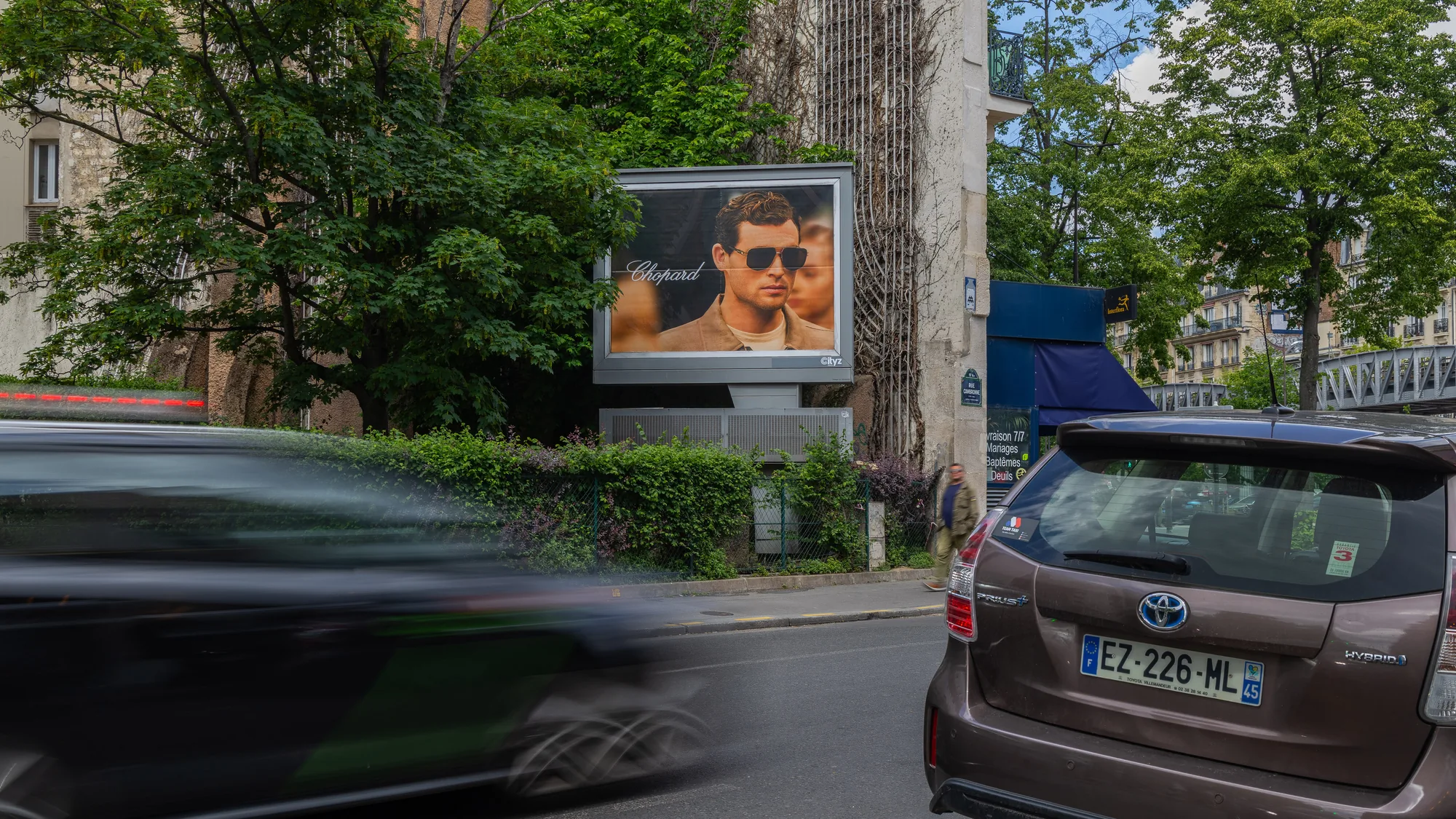 Digital out-of-home advertising in Paris, in France: a ba&sh screen with Abby Champion covers the Galeries Lafayette facade at night.