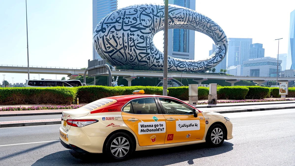 Taxi advertising in Dubai, in the UAE: a taxi carries a McDonald's door advert reading Wanna go to McDonald's?