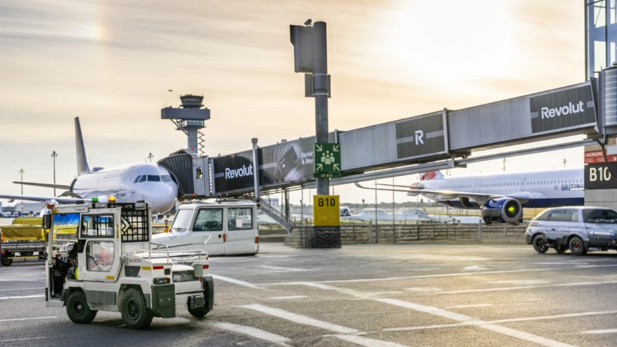 Airport advertising at Berlin Airport in Germany: Revolut runs along the airbridge, with aircraft parked on the apron below.
