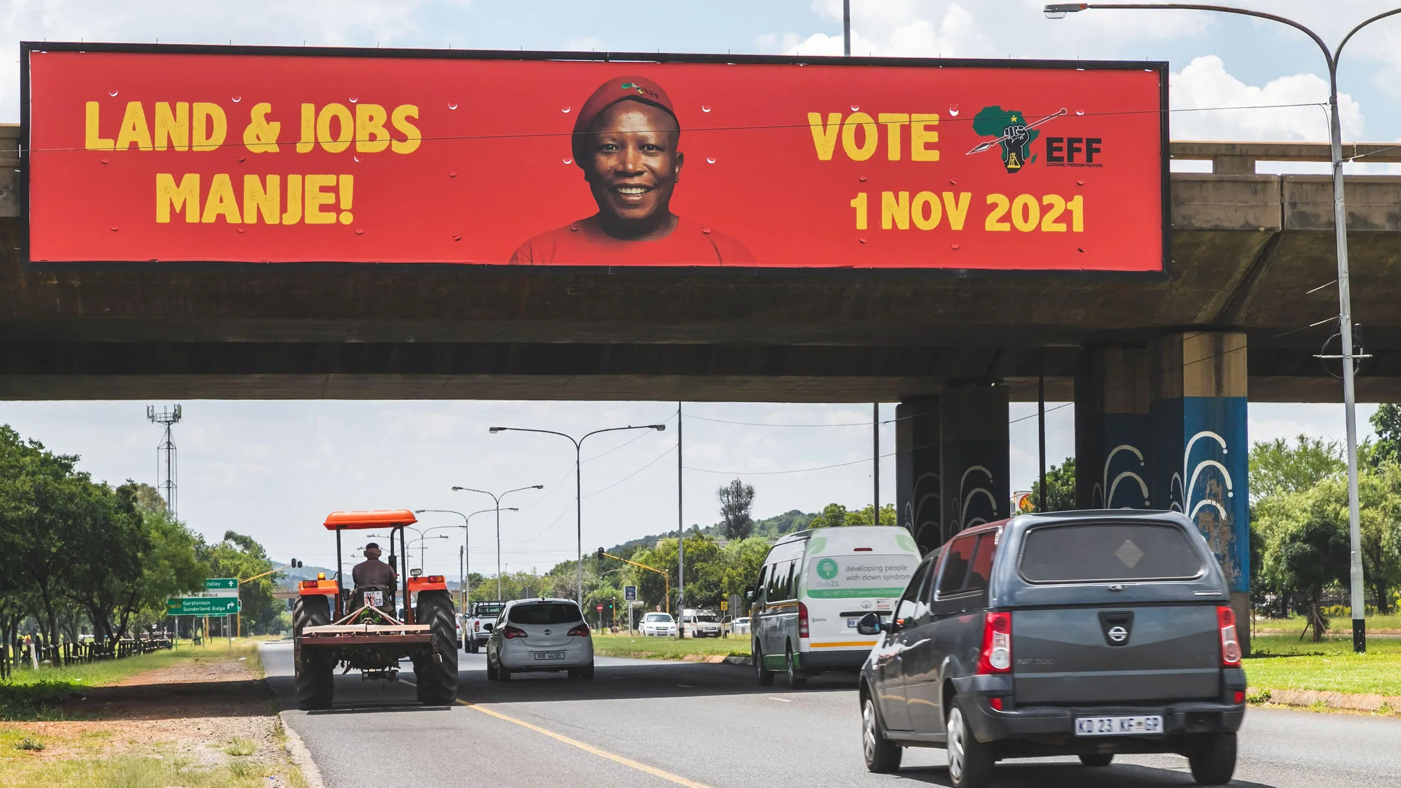 Bridge banner advertising in South Africa: a red banner for the EFF reads Land & Jobs Manje, vote 1 Nov 2021.