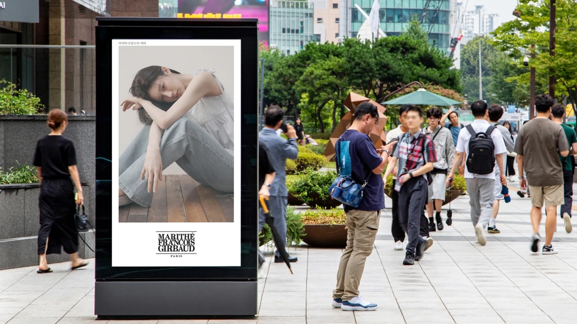 Programmatic digital advertising in South Korea: a digital panel on a pedestrian street shows a Marithé François Girbaud advertisement.