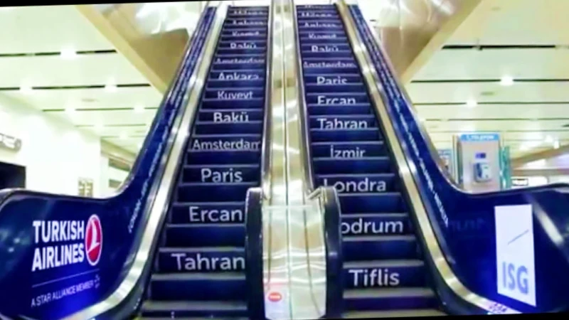 Airport escalator advertising: Turkish Airlines branding wraps one side, the steps list cities including Paris, Amsterdam and London, and an ISG panel sits on the other.