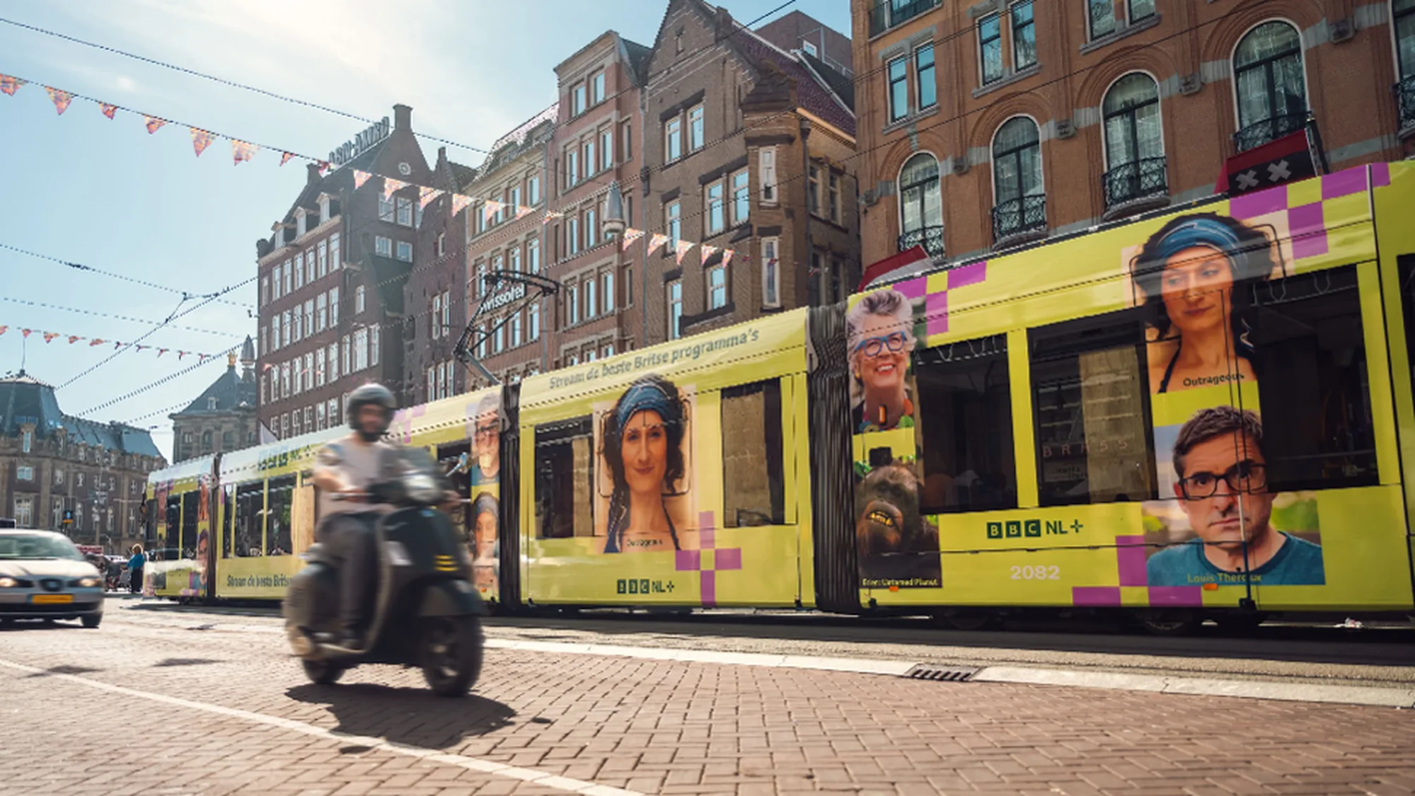 Rail advertising at Manchester Piccadilly in the United Kingdom: passengers fill the concourse beneath departure boards and a Trains on Uber banner.