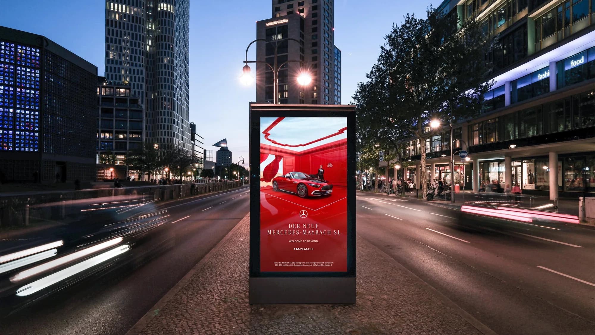 Street furniture advertising: a pavement screen advertises the new Mercedes-Maybach SL on a city street at dusk.