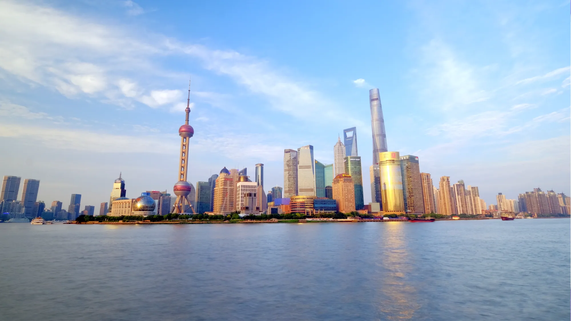 The Oriental Pearl Tower and Shanghai's supertalls rise across the river on the Pudong skyline.