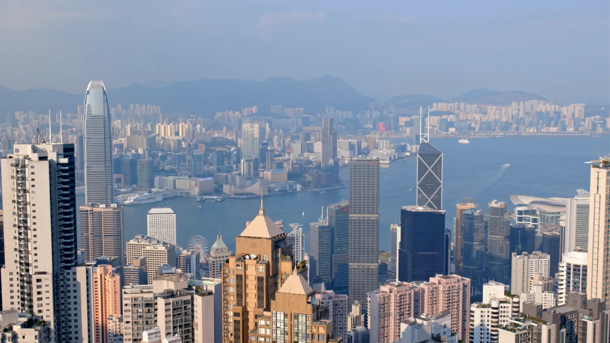 Dense towers crowd Victoria Harbour in Hong Kong, with the Bank of China building beside the water.
