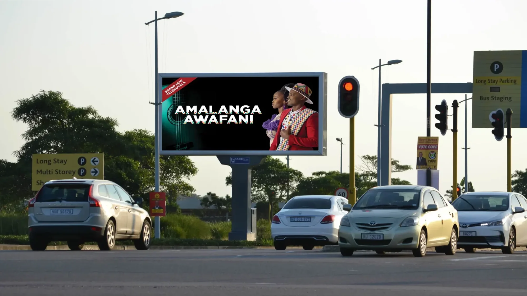 Billboard advertising in Pretoria, South Africa: an arched board shows a BMW campaign, We are rewriting the rules, near a sign for Menlyn.