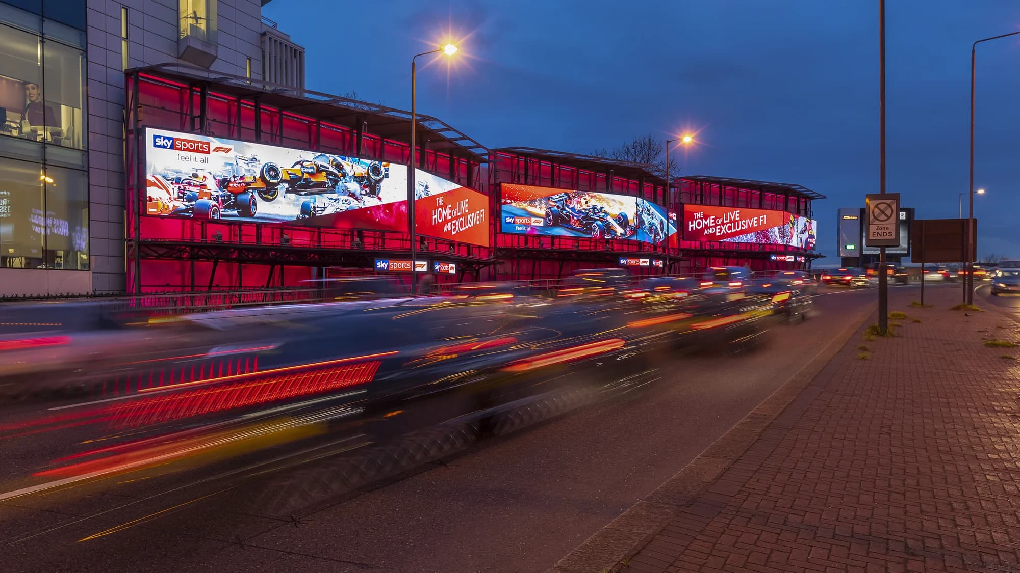 Billboard advertising at Piccadilly Lights in London, in the United Kingdom: a Walkers screen reads No Walkers, no game, with three men on a sofa.