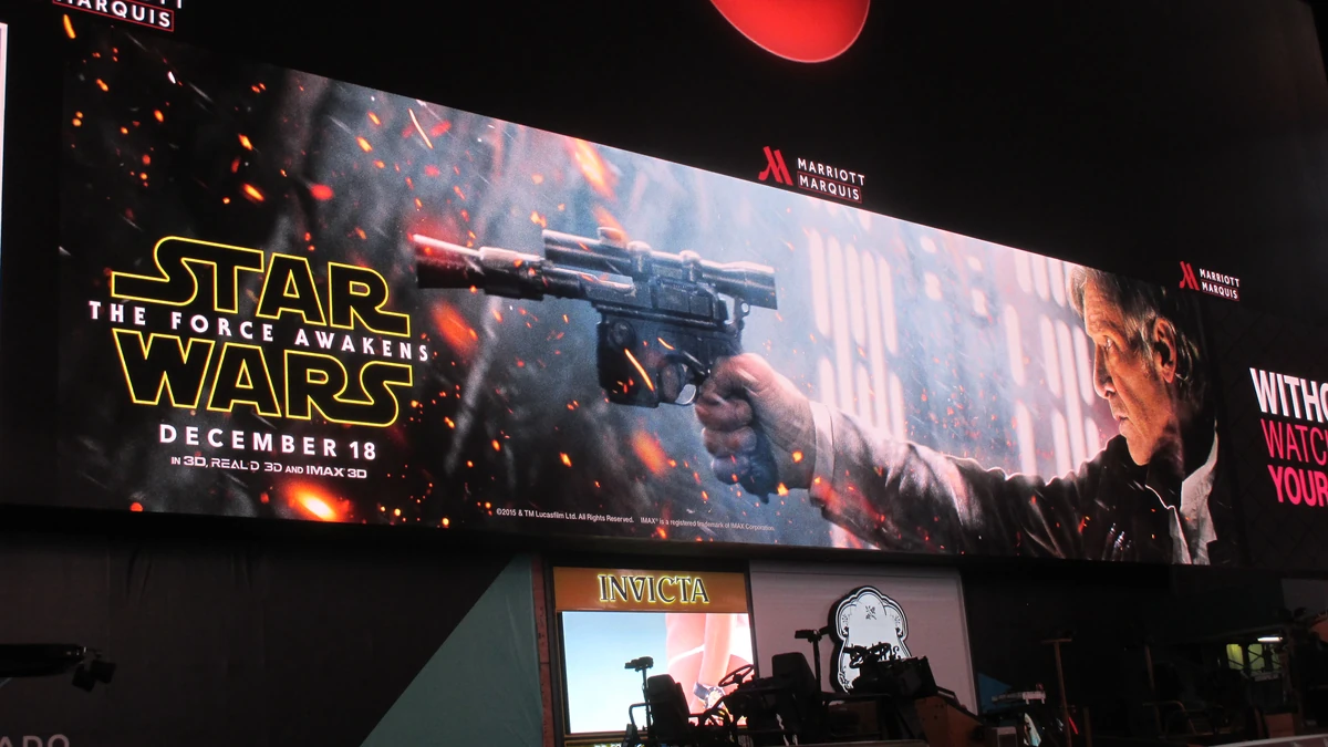 Backlit billboard advertising: a Marriott Marquis screen shows Harrison Ford for Star Wars: The Force Awakens, dated December 18, with an Invicta shop below.