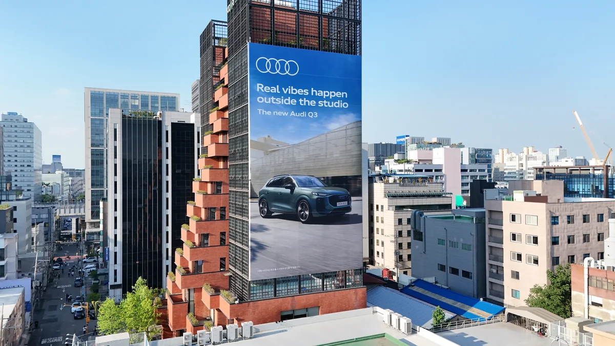 Facade banner advertising: a vertical Audi banner for the new Q3 covers the face of a tower.