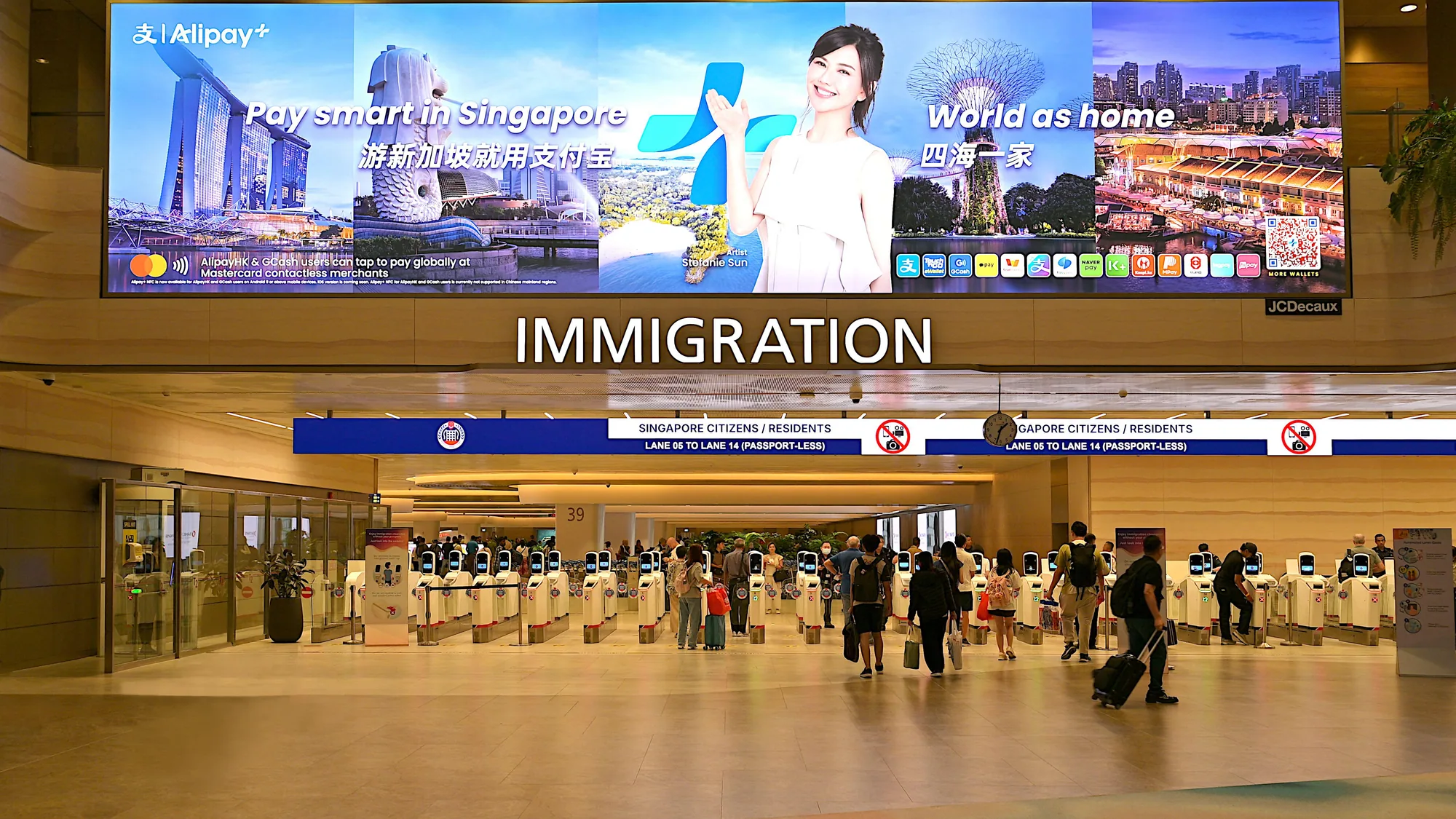 Airport advertising at arrivals: a Marriott Bonvoy screen hangs above the Terminal 1 immigration gates.