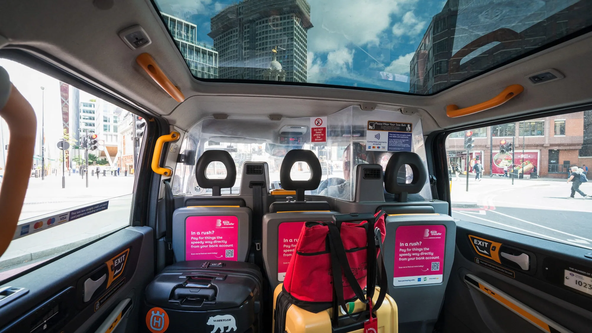 Taxi interior advertising: a Honda Civic poster is fixed to the back of a seat in front of a passenger.