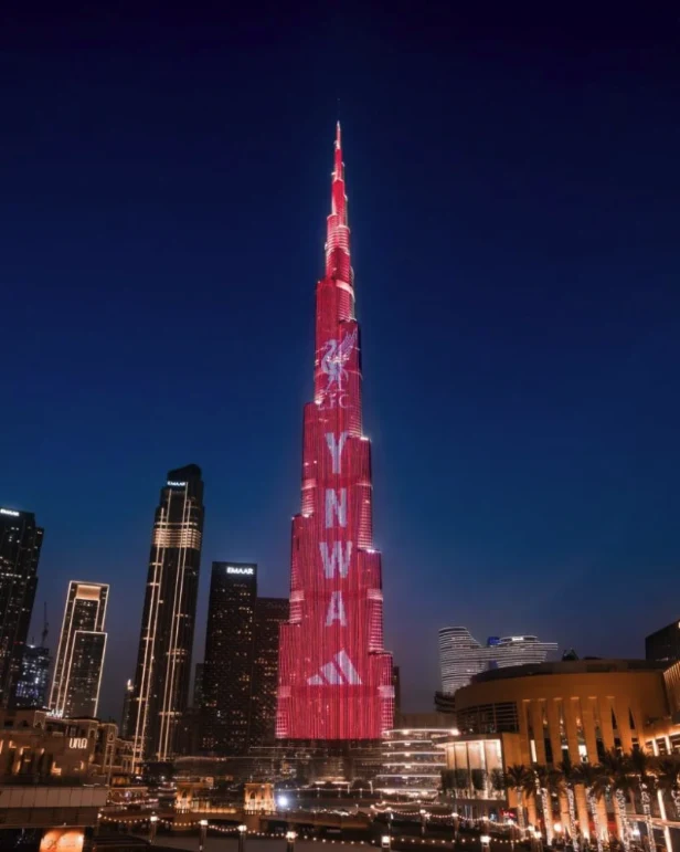 Building projection advertising at the Burj Khalifa in Dubai, in the UAE: a red Liverpool FC display with YNWA lettering and an Adidas logo covers the tower at night.